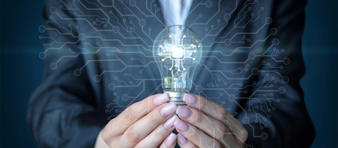 A businesswoman holding a lightbulb