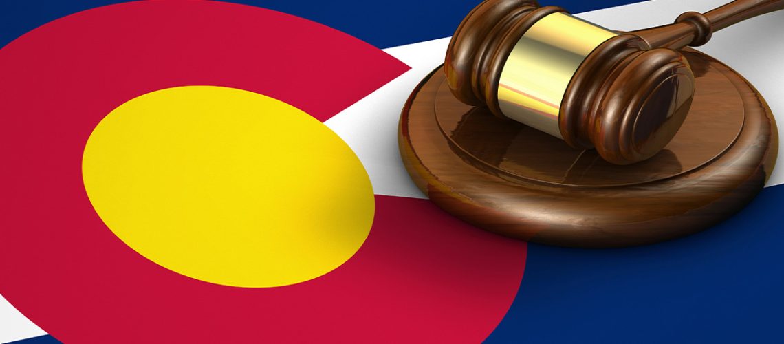 The Colorado state flag with a wooden gavel on top