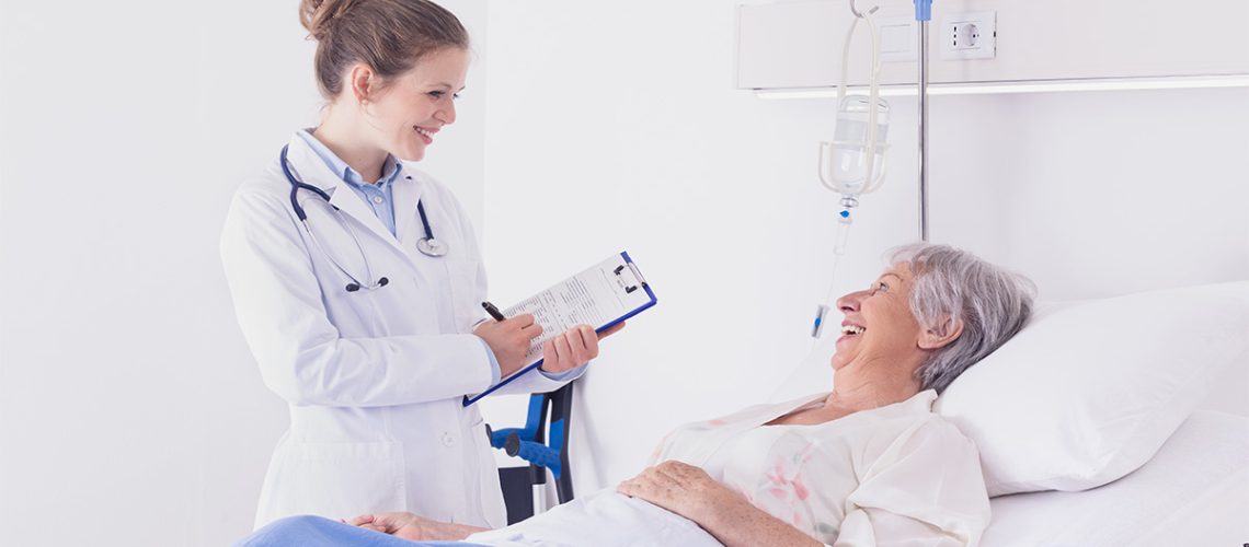 A patient and administrator chat with a clipboard